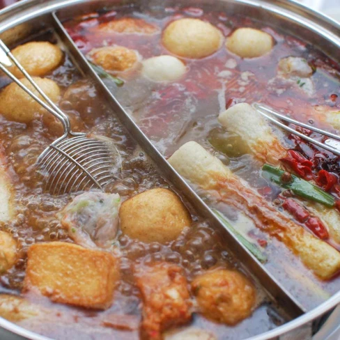 Chinese-Style Hot Pot With Rich Broth, Shrimp Balls, and Dipping Sauces Image