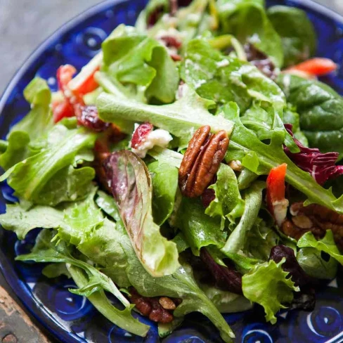 Mixed Green Salad With Pecans, Goat Cheese, And Honey Mustard Vinaigrette Image